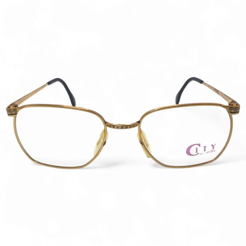 Front view of Zeiss City Collection golden eyeglasses with intricate circular engravings on the bridge and temples.